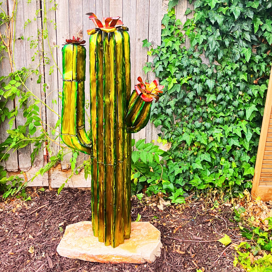 Metal Cactus Sculptures on wooden stumps, displayed on a faded background