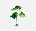 metallic green plant with leaves, stem and round base. metal sculpture designed to look like monstera plant.