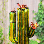 Close up of tall cactus sculpture with flowers on a blurred garden background
