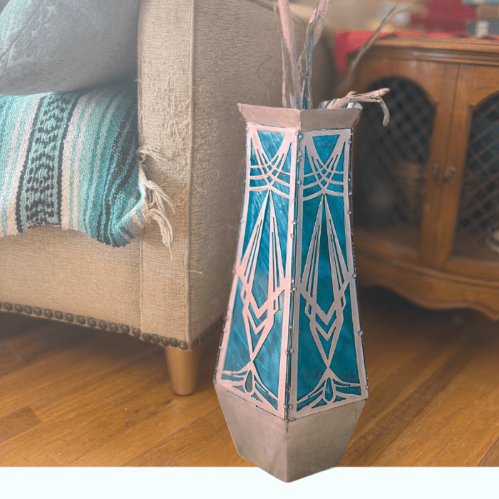 decorative metal vase with teal accents on a living room background