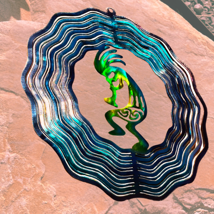 Decorative metal art piece with a stylized kokopelli figure on a textured surface