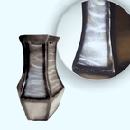 Decorative vase with a close up on a textured surface on a white background