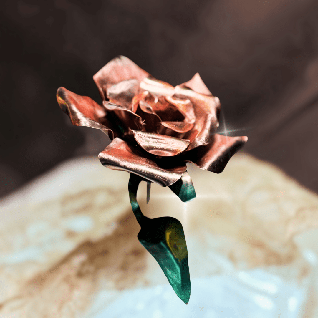 Pink rose-shaped object on a textured surface with a blurred background