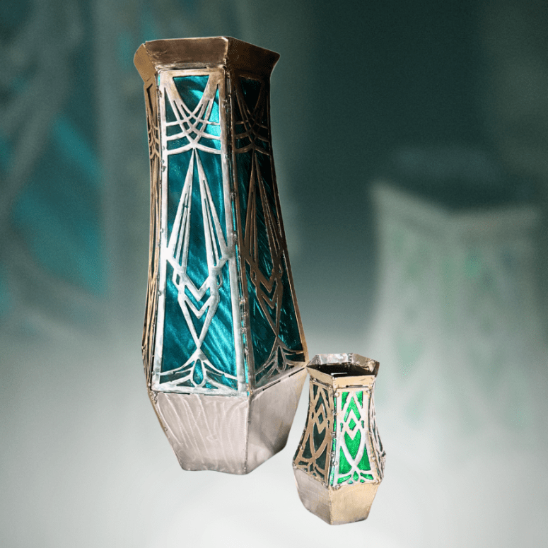 Decorative metal vases with geometric patterns on a gradient background