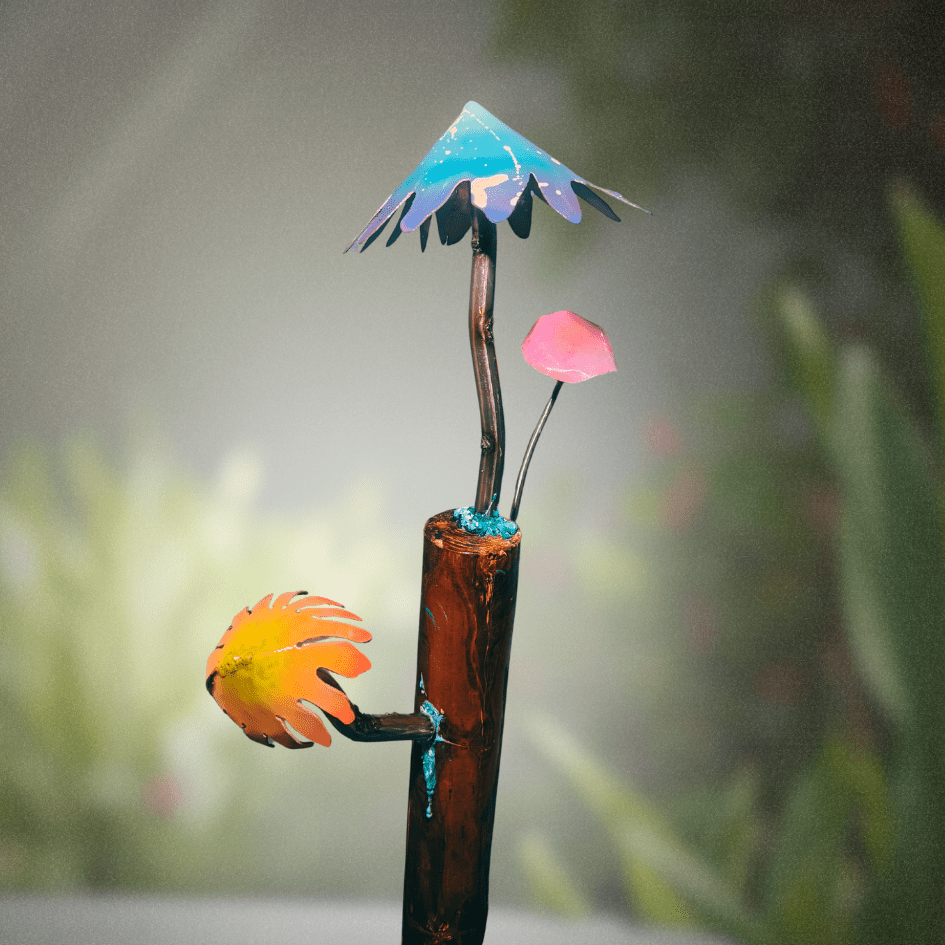 Decorative garden stake with colorful mushrooms and an umbrella-like top against a blurred green background
