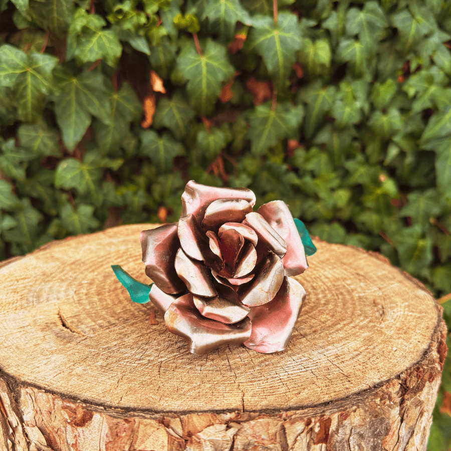 Decorative flower on a wooden stump with a green leafy background