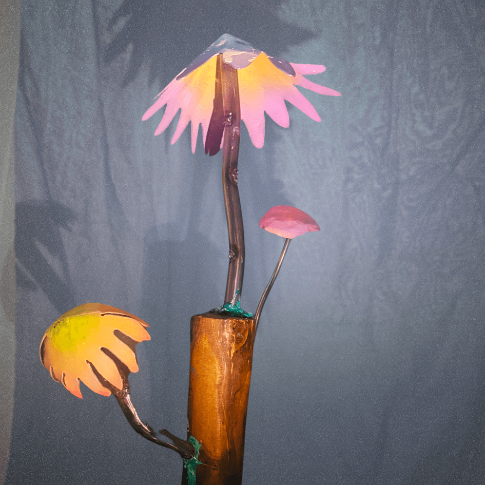 Artistic representation of mushrooms with a wooden base against a blurred gray background