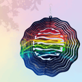 Colorful geometric wind spinner with a gradient of colors on a soft, multicolored background.
