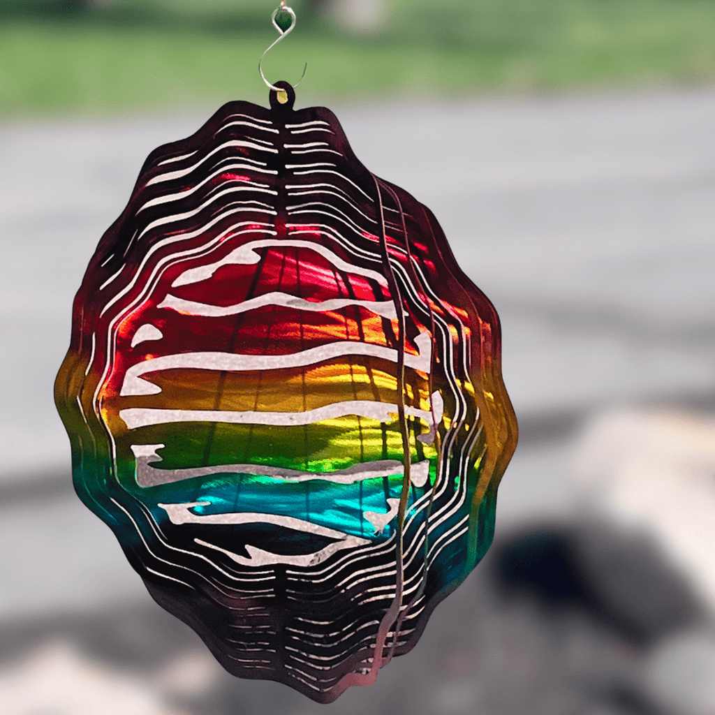 Colorful wind spinner hanging outdoors with a blurred background