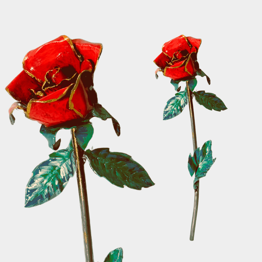 Two red roses with green leaves on a white background