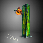 Artistic green painted metal cactus sculpture with floral elements on a gray background