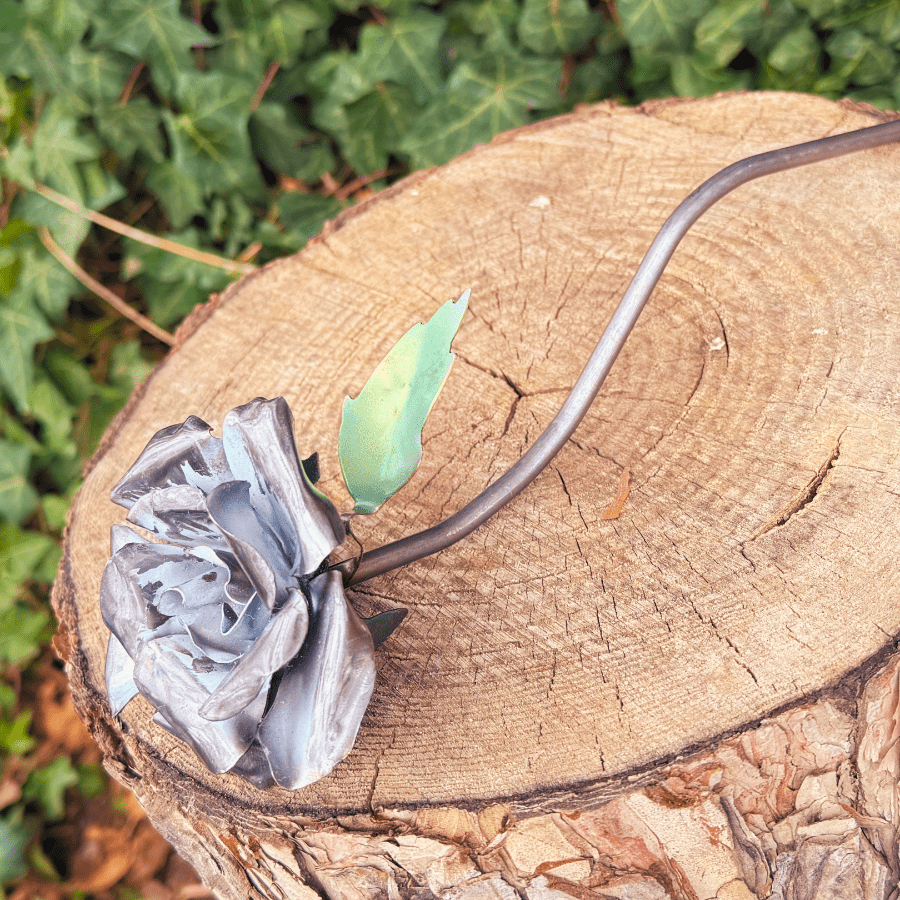 Metallic flower headband on a wooden log with greenery in the background