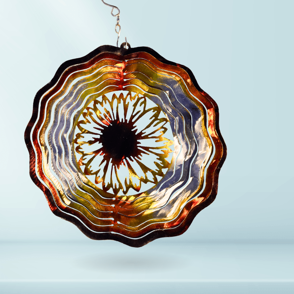 Metal Windspinner with sunflower in center, on a blue background
