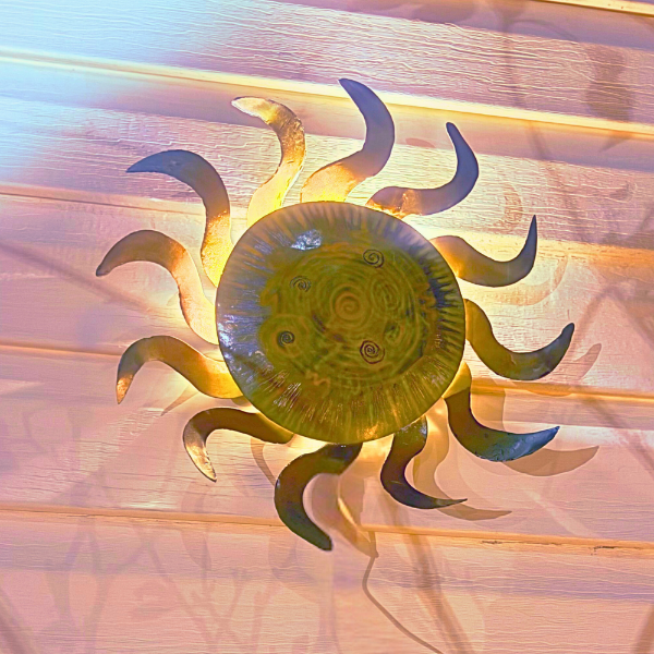 Decorative sun wall art on a textured wall