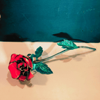 Red Rose, Metal art with green leaves, on a tan and black background
