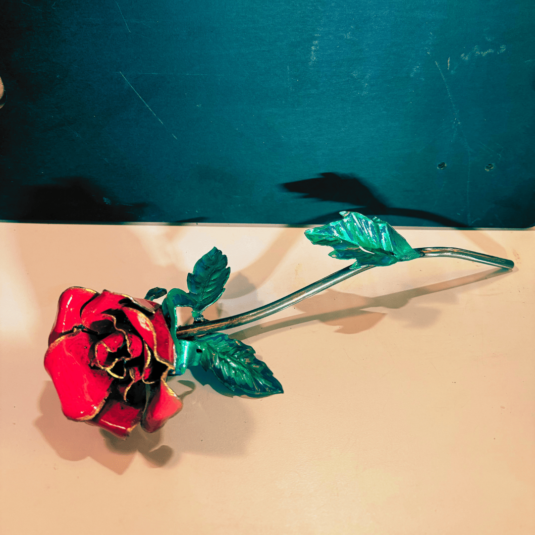 Red Rose, Metal art with green leaves, on a tan and black background