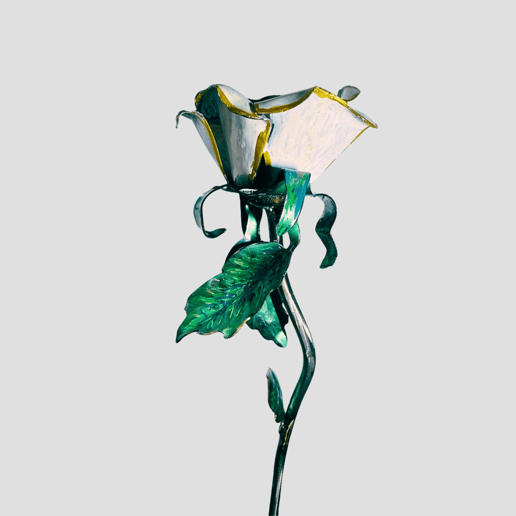 White and gold painted rose, handmade from metal, painted. On a gray background