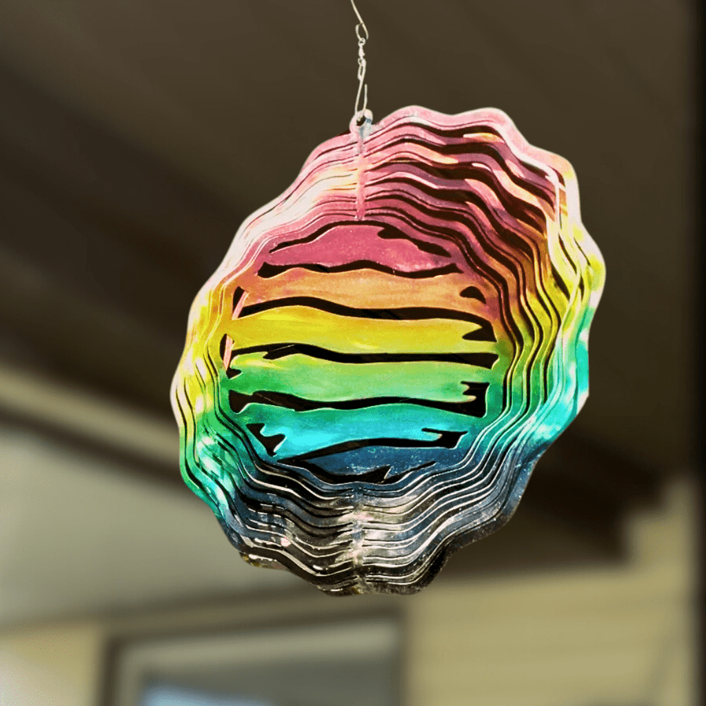 Colorful geometric wind spinner hanging against a blurred background
