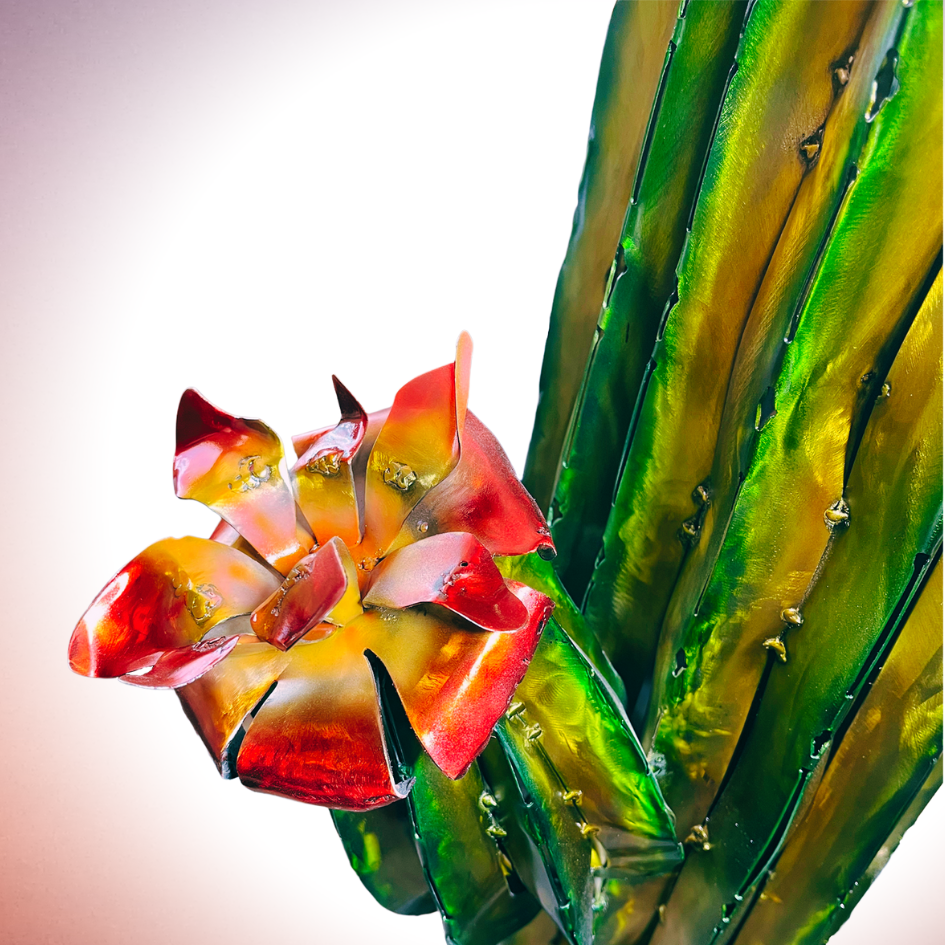 Close up of Metal cactus and red flower on tip of nub, on a pink background