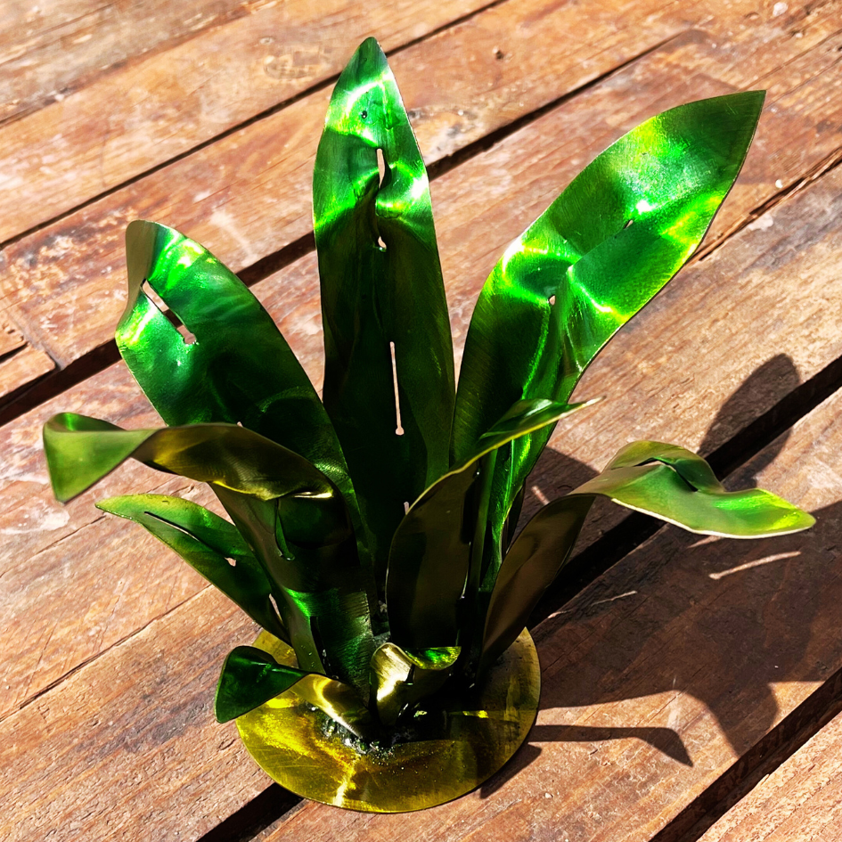 Artificial green plant on a wooden surface