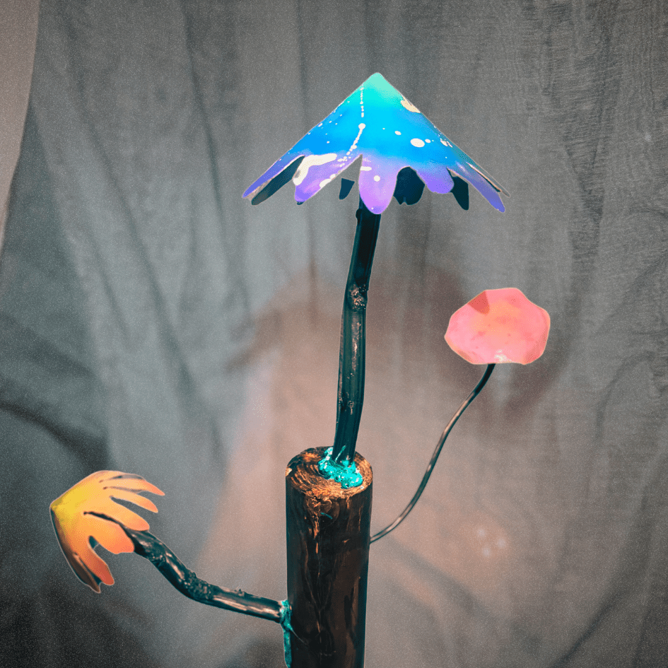 Artistic depiction of mushrooms on a log with colorful metal mushrooms against a gray background