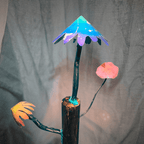 Artistic depiction of mushrooms on a log with colorful metal mushrooms against a gray background